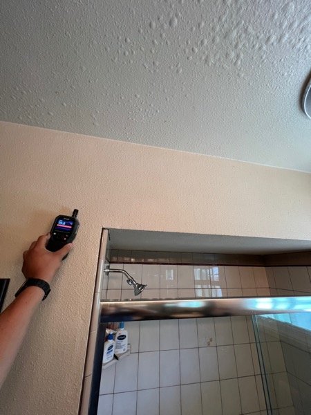 Thermal moisture meter checking a bathroom vanity area