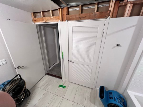 Controlled drywall removal in a hallway following water intrusion